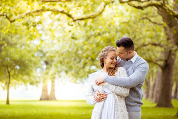 Fototapeta premium Young couple walking, Hyde Park, London: sunset colour tone
