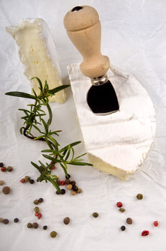 camembert with cheese knife and colored pepper