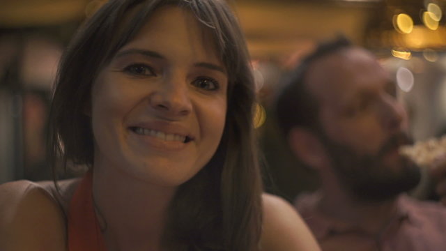 Couple in cafe at night, portrait of pretty, happy woman 
