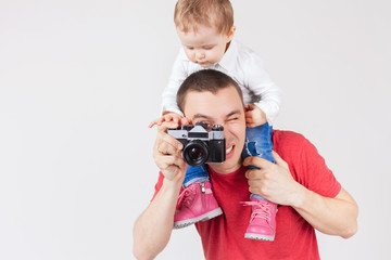 Funny father and child making selfie at vintage camera