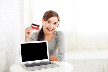 Woman holding credit card for online shopping