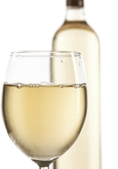 Wineglass and bottle with white wine