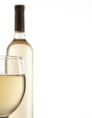 Wineglass and bottle with white wine