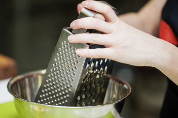 She rubbed grated cheese product.