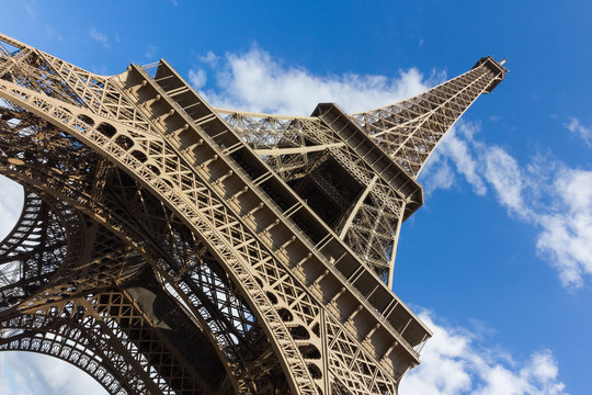 Eiffel tower, paris. View from below. Blue sky, white clouds