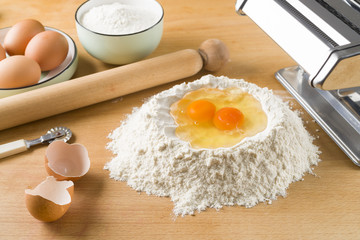 raw egg pasta with flour and rolling pin