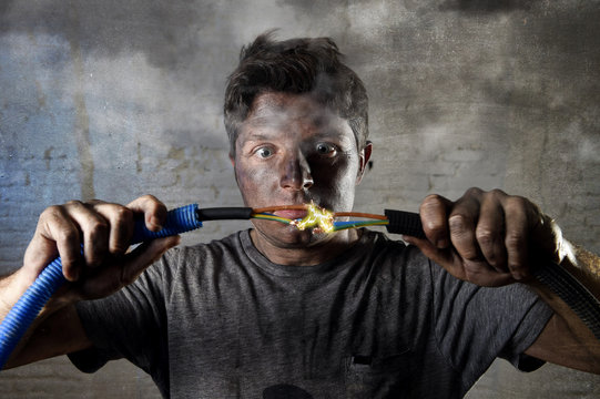 untrained man joining cable suffering electrical accident with dirty burnt face shock expression