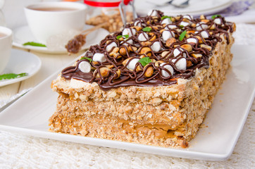 Cake with caramel cream, meringue and 
peanuts