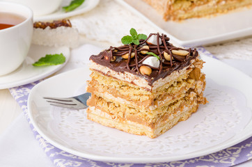 Cake with caramel cream, meringue and 
peanuts