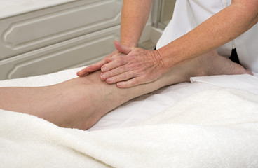 Fototapeta na wymiar A masseuse massaging a clients leg