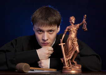 Male judge in a courtroom striking the gavel