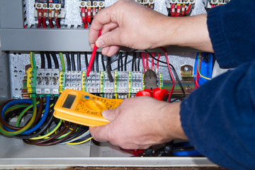 electrician at work with an electric panel
