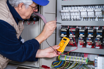 electrician at work with an electric panel