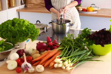 Young Woman Cooking in the kitchen. Healthy Food