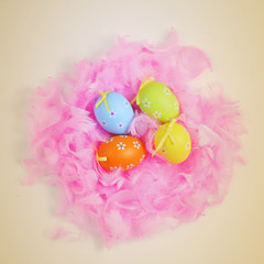 decorated eggs in a nest of feathers