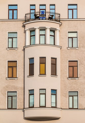 Fototapeta na wymiar Many windows in row and bay window on facade of urban apartment building front view, St. Petersburg, Russia.