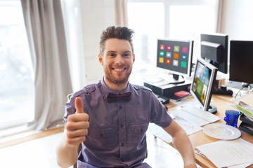 happy male office worker showing thumbs up