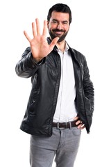 Man with leather jacket counting five