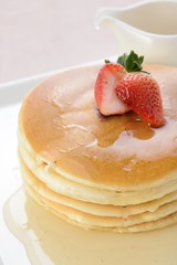 Delicious pancakes with honey on plate 