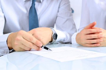 Two business partners signing a document