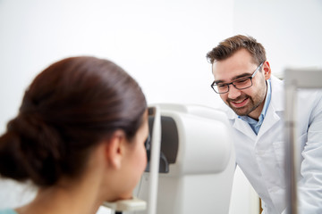 Fototapeta premium optician with tonometer and patient at eye clinic