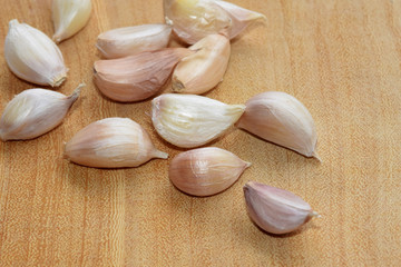 Garlic  cloves - Allium sativum  close up on wood floor