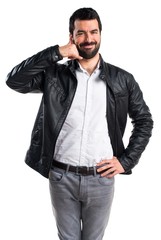 Fototapeta premium Man with leather jacket making phone gesture