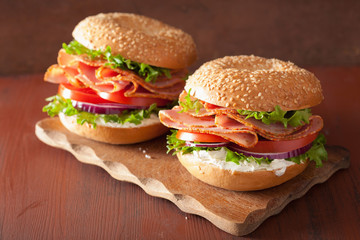 ham sandwich on bagel with cream cheese tomato onion
