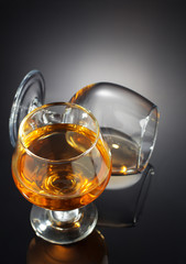 cognac and  glass  on black