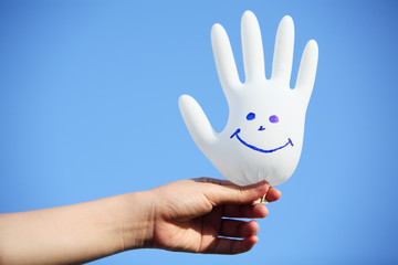 hand holding smiling glove