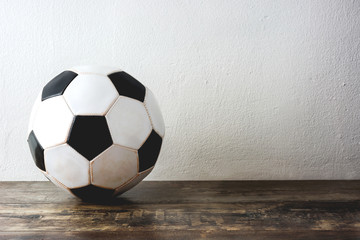 Old Soccer football on wood
