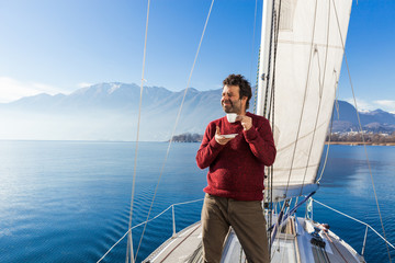 men makes a coffee break on sailboard