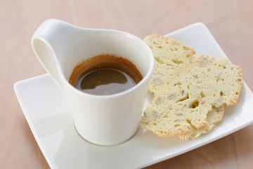 Cup of espresso with biscuit as snack