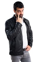 Fototapeta premium Man with leather jacket showing something