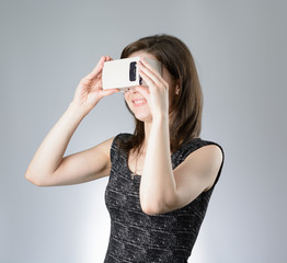 Young woman playing a virtual reality glasses