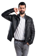 Man with leather jacket doing bad signal