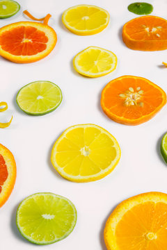 Bright colorful design of various citrus fruit slices with oranges, lemons, limes, grapefruit and tangerines. 