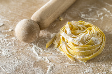 raw egg pasta with flour and rolling pin