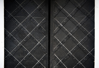 texture of black old metal door with rivets for background
