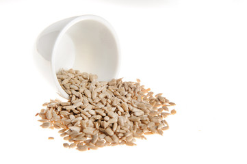 Pile of sunflower seeds isolated on white background. Close up of peeled  sunflower seeds isolated...