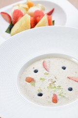 A bowl of oat serve with fruits