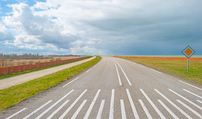 Fototapeta premium Road over a dike along a lake in winter