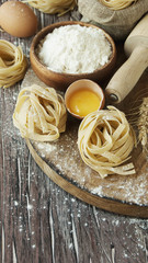 Uncooked pasta with flour on the table, selective focus