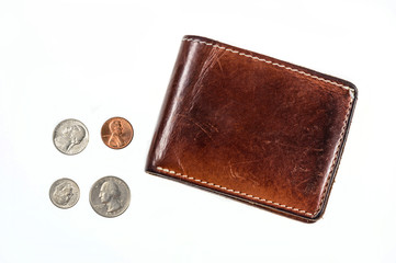 US coins spilling out of open leather wallet