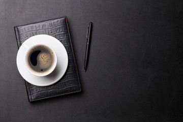 Office leather desk table with coffee and supplies