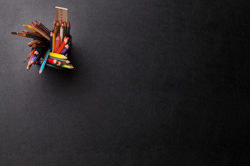 Office leather desk table with colorful pencils