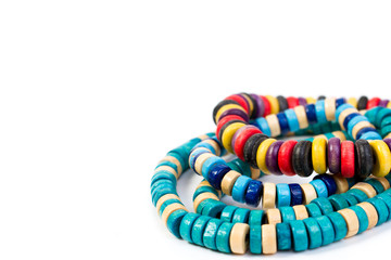 colored wooden bracelets on a white background