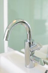 Metal faucet in bathroom