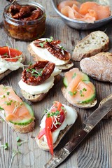Appetizers. Toasts with salmon, dried tomatoes and sweet peppers
