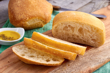 Sliced bread Ciabatta and virgin Olive oil on wooden background